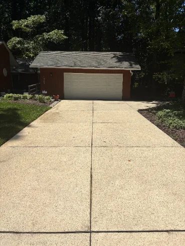 Clean bright concrete driveway after pressure washing