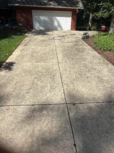 Stained concrete driveway before pressure washing