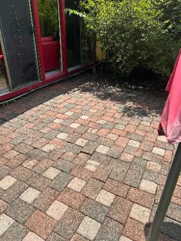 Paver patio restored to original color after pressure washing