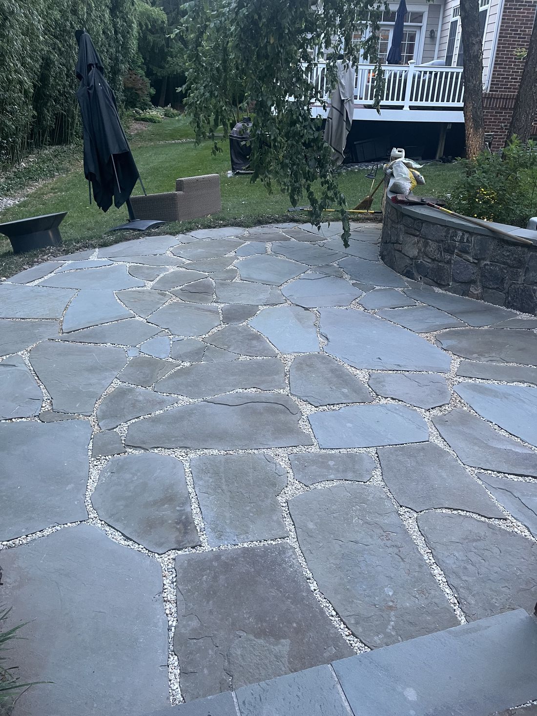 Flagstone patio after cleaning, joints filled with locked decorative pebbles