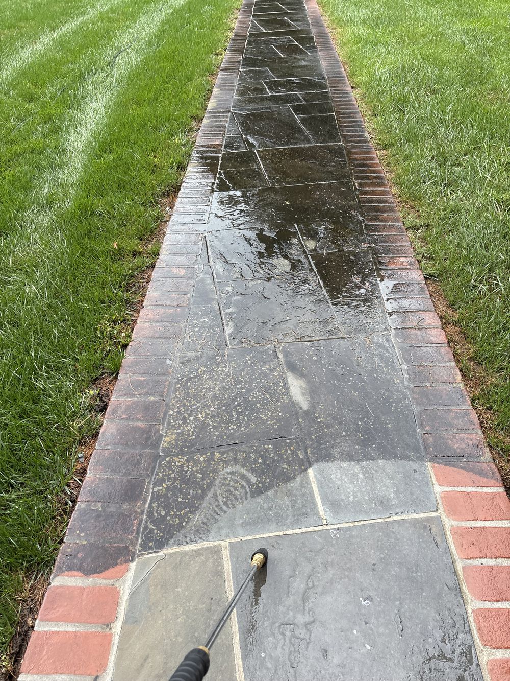 Pressure washing a slate and brick walkway