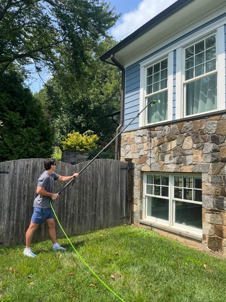 Exterior window cleaning with a deionized water fed pole on a home in Bethesda MD